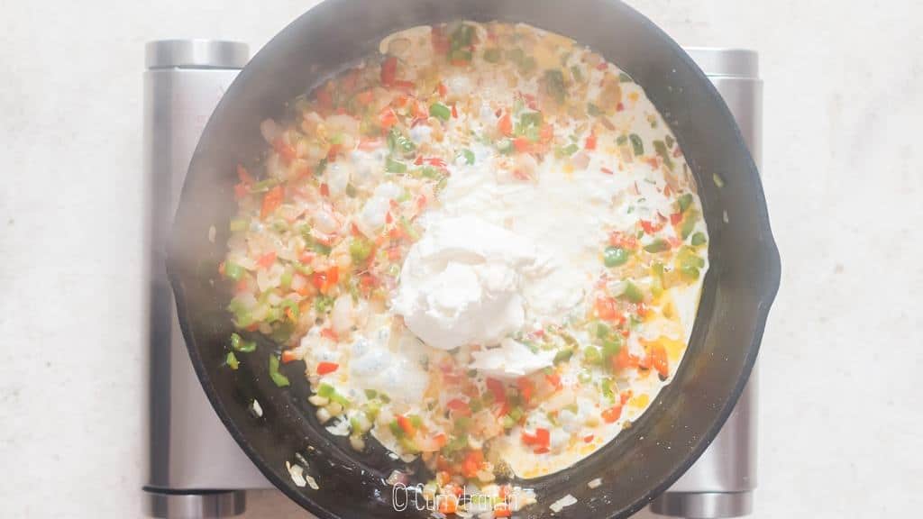 cream cheese, evaporated milk added to cast iron pan