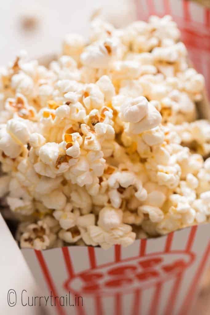 close up view of movie style popcorn served in popcorn tubs