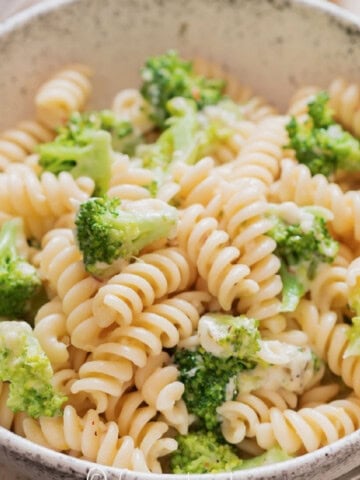 a bowl full of broccoli pasta.