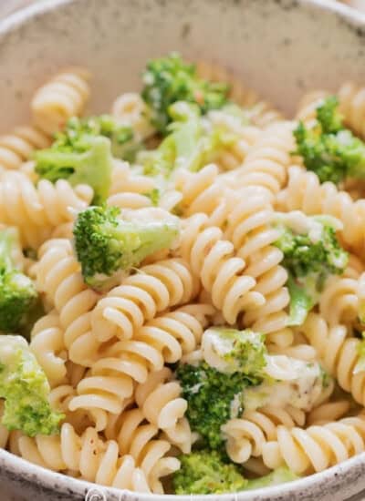 a bowl full of broccoli pasta.