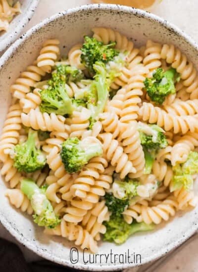 broccoli fusilli pasta served in ceramic bowl with lemon on side