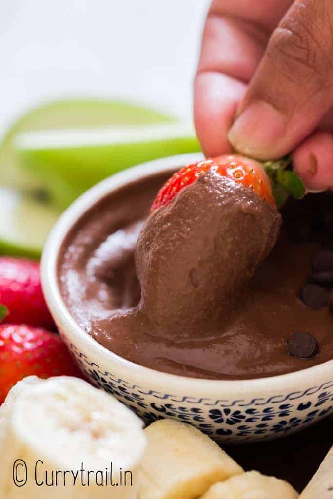 strawberry dipped in brownie batter hummus