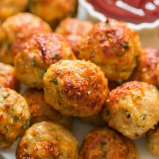 oven baked chicken meatballs served in plate with ketchup
