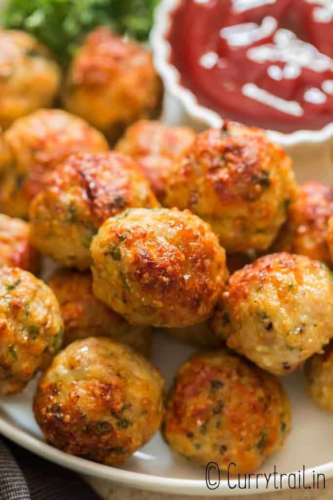 oven baked chicken meatballs served in plate with ketchup