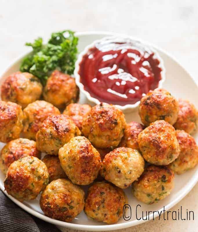 oven baked chicken meatballs served in plate with ketchup