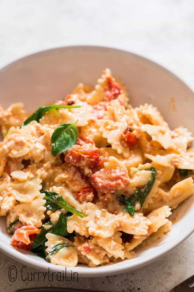 bowl of feta cheese and cherry tomato pasta