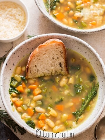 two bowls of bean soup with kale