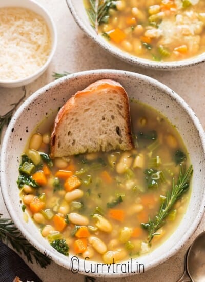 two bowls of bean soup with kale