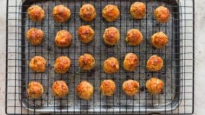 baked chicken meatballs on baking tray with wire rack