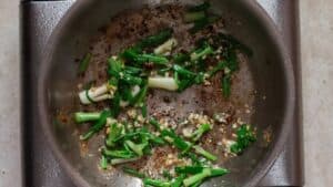 scallions, ginger, garlic in skillet