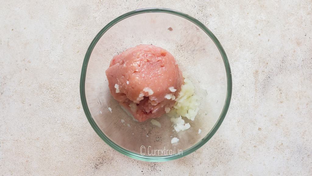 ground chicken and grated onion in bowl