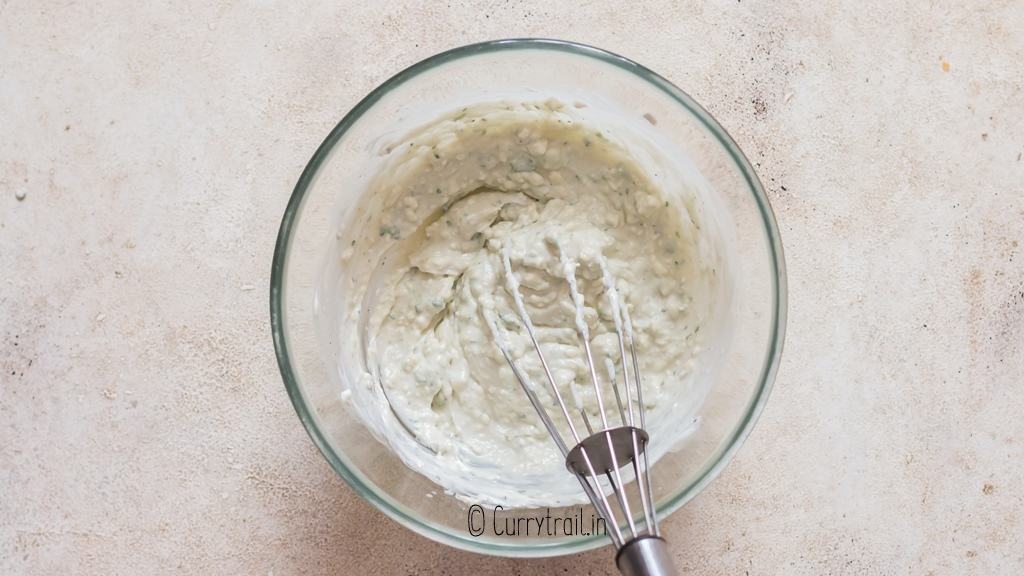 whisking blue cheese dressing in bowl