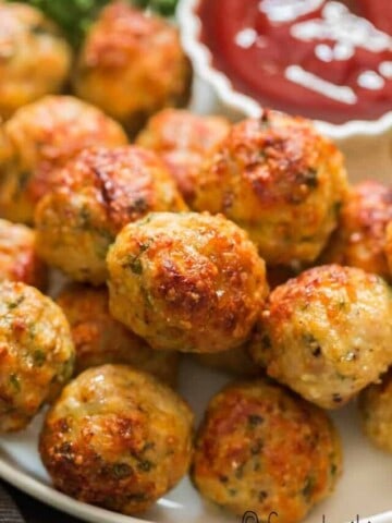 oven baked chicken meatballs served in plate with ketchup