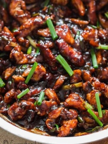 close up view of Mongolian chicken cooked in skillet.