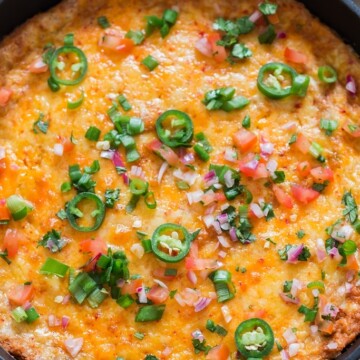 cheesy refried bean dip in cast iron skillet
