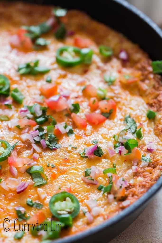 close up view refried bean dip in cast iron skillet