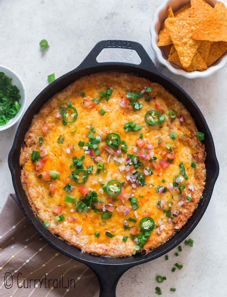 refried bean dip cooked in cast iron pan