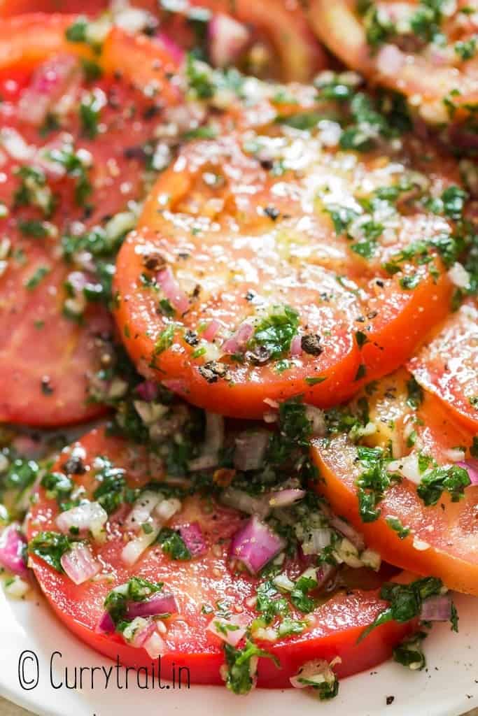 close up of marinated tomato salad on plate