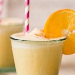 2 glasses of orange Julius with straw