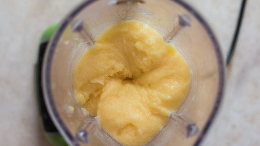 thick dole whip made of pineapple in a blender.