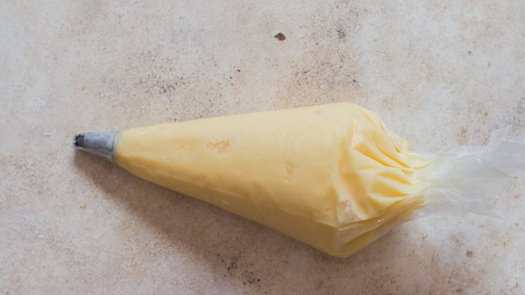 piping bag with dole whip on a table.