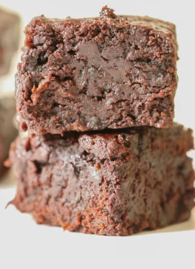 zucchini brownies stacked one on top of each other.