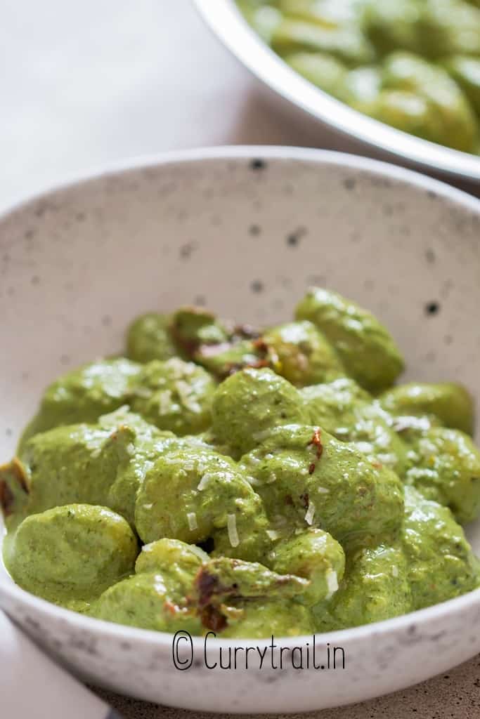 close up view of pesto gnocchi in bowl