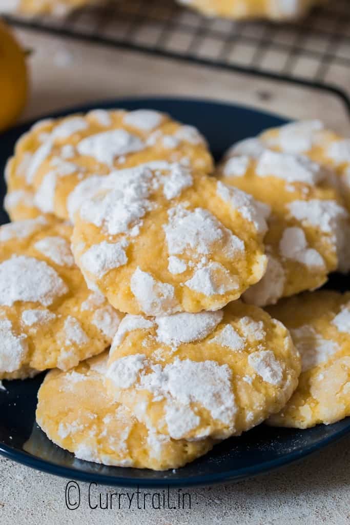 lemon crinkle cookies stacked on plate