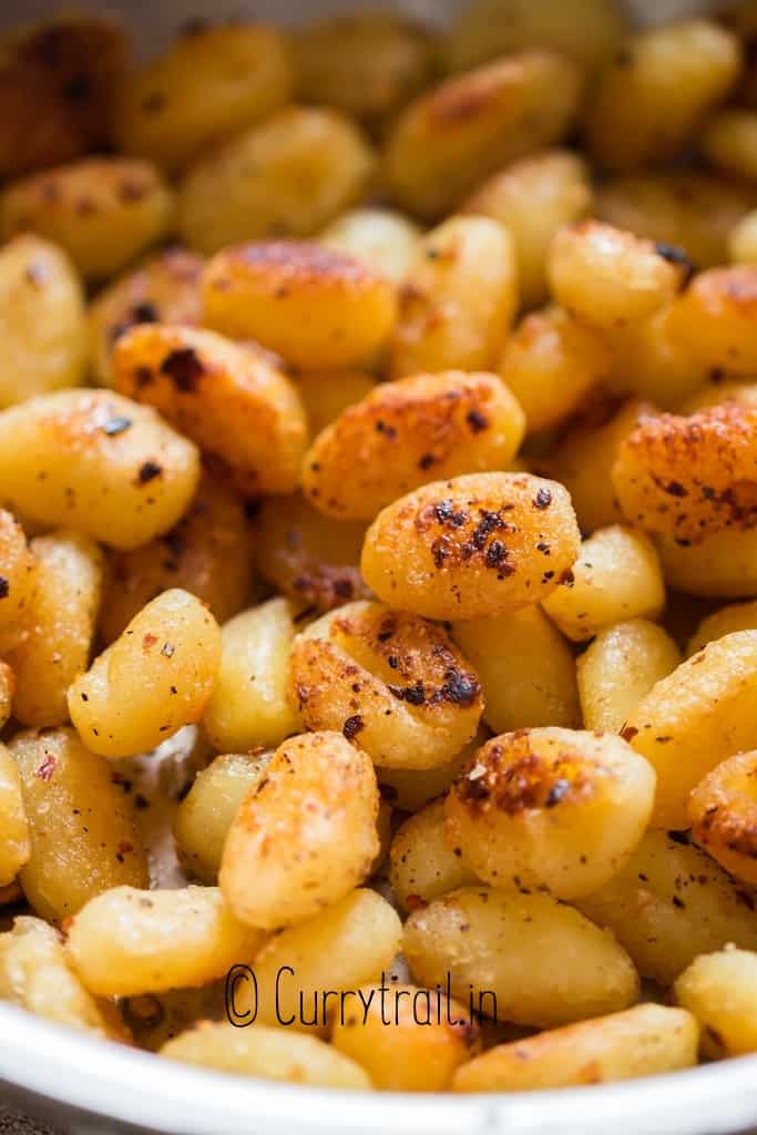 fried gnocchi in garlic butter sauce in skillet