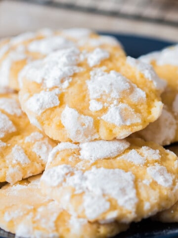 lemon crinkle cookies stacked on plate