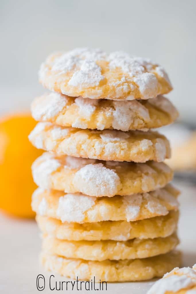 lemon crinkle cookies stacked on plate