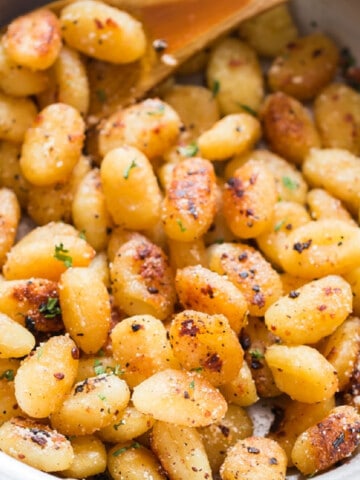 fried gnocchi in garlic butter sauce in skillet