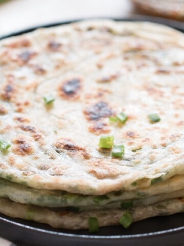 scallion pancakes stacked on top of each other