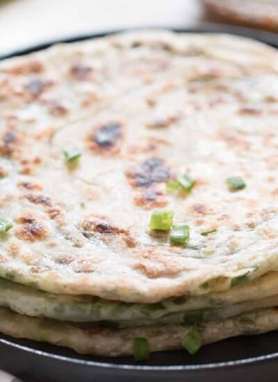 scallion pancakes stacked on top of each other