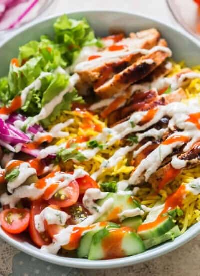 easy chicken shawarma bowl with hummus dressing and red chili sauce