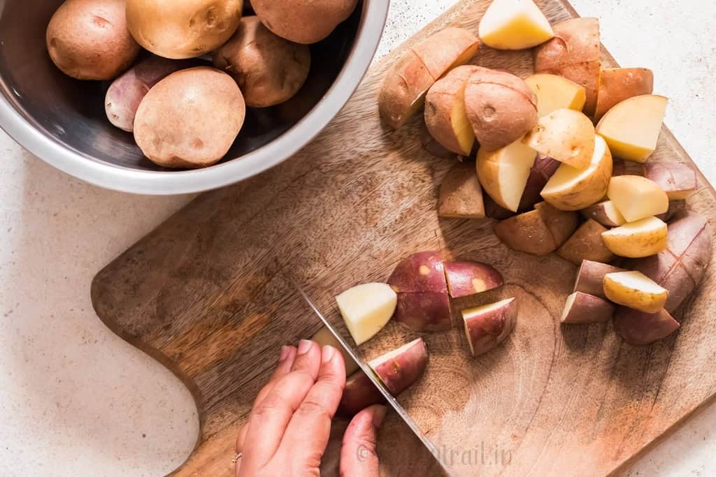 dicing potatoes on a wooden board.