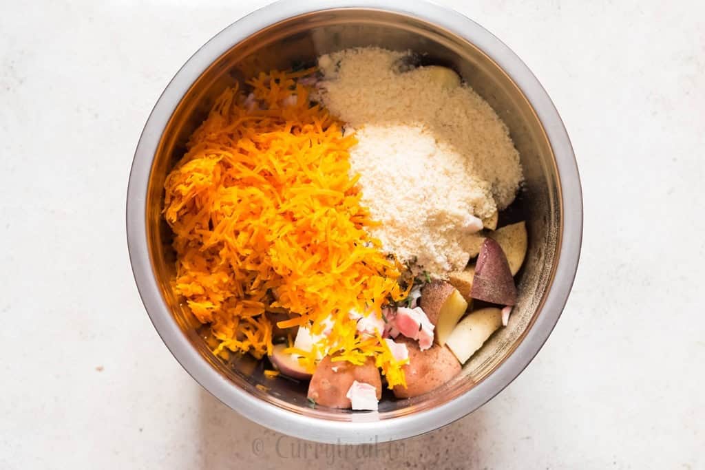 mixing potatoes with cheese in a bowl.