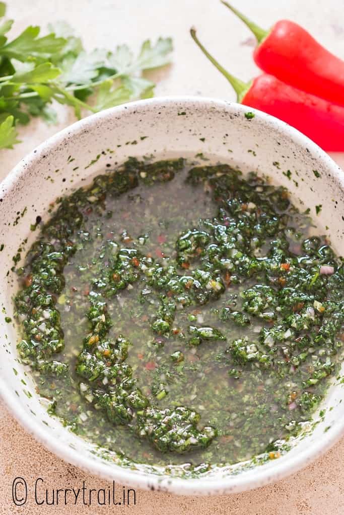 making chimichurri sauce in bowl