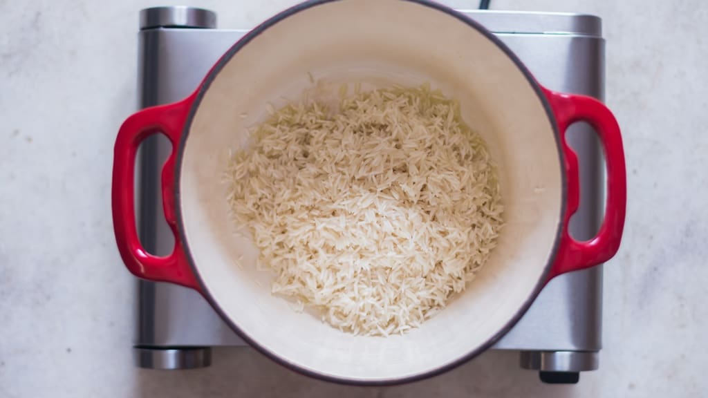 cooking rinsed long-grain rice in a pot.
