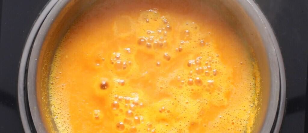 cooking hot sauce with mango and habanero peppers.