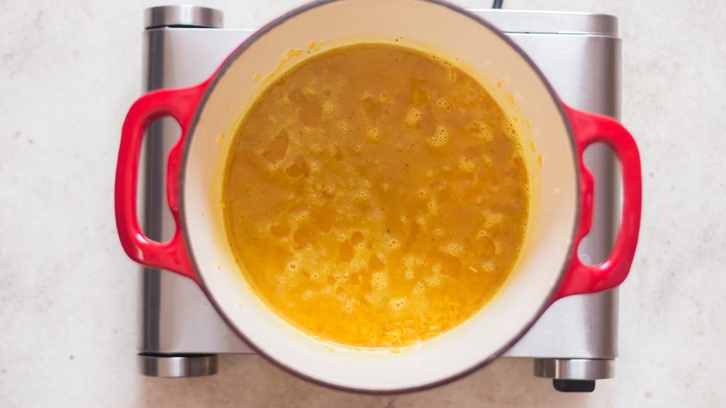 cooking turmeric rice in a pot.