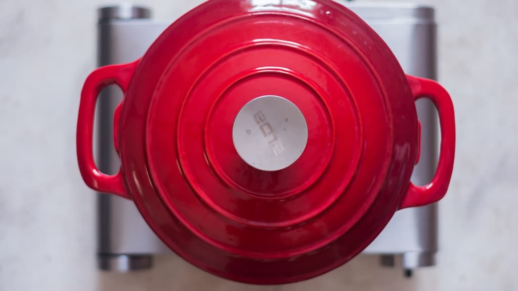 cooking turmeric rice in a pot with lid covered on.