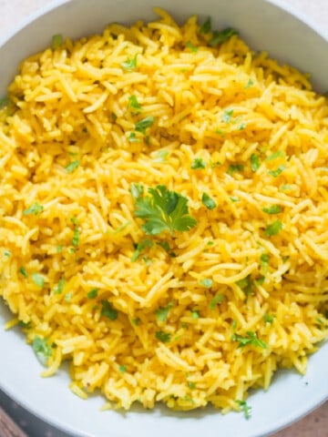 vibrant yellow rice in ceramic bowl