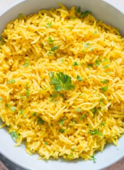 vibrant yellow rice in ceramic bowl