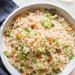 garlic fried rice with crispy garlic chips and scallions as garnish on top