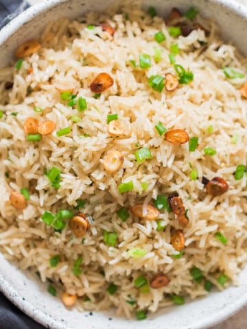 garlic fried rice with crispy garlic chips and scallions as garnish on top