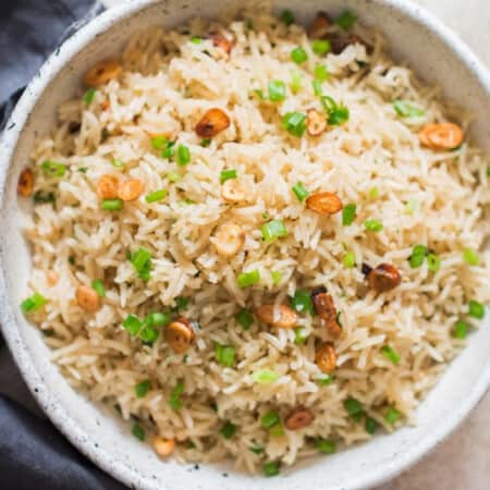 garlic fried rice with crispy garlic chips and scallions as garnish on top