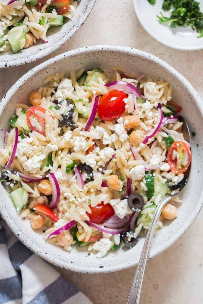 pasta salad made using orzo pasta and feta cheese