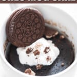 mug cake made of oreo and milk served with whipped cream and oreo crumbs on top with text