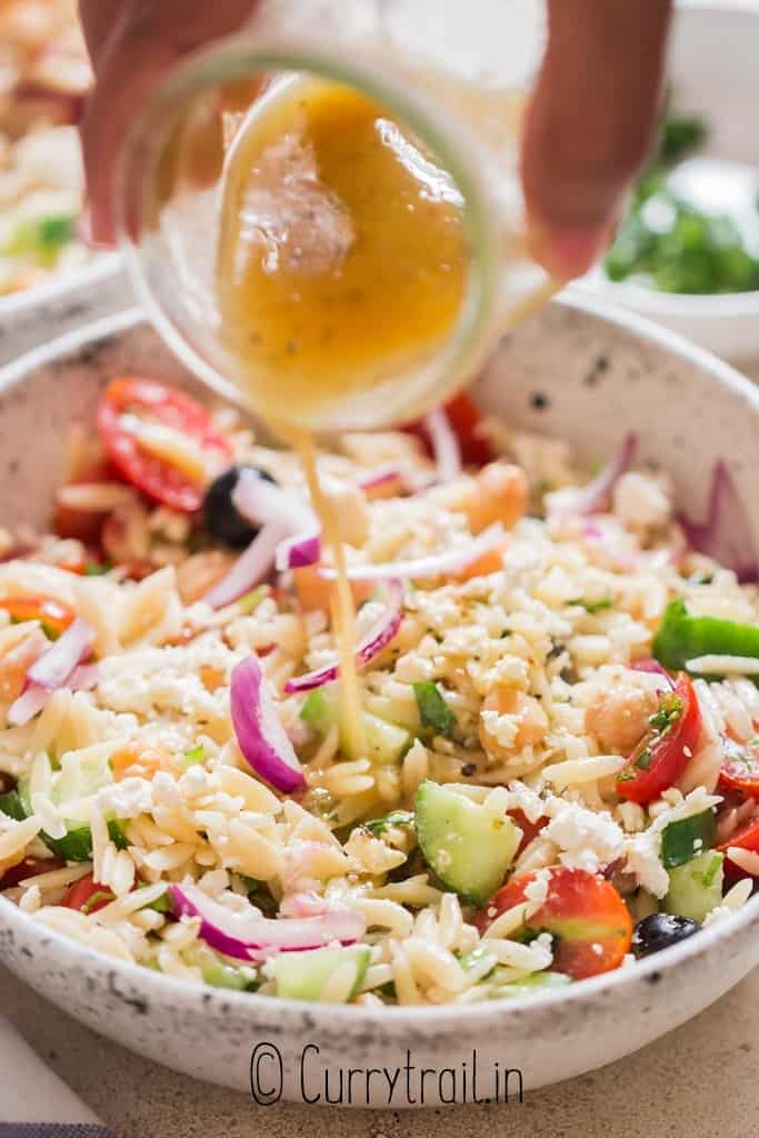 pasta salad with Greek salad dressing drizzled on top